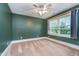 Spacious bedroom with neutral carpet, a ceiling fan, and a window for natural light at 2353 Woodcreek Crossing Blvd, Avon, IN 46123