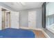 Bedroom with a blue bed, light-gray walls, carpet, and a window at 2353 Woodcreek Crossing Blvd, Avon, IN 46123