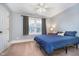 Bedroom with a blue bed, light-gray walls, carpet, and a window with natural light at 2353 Woodcreek Crossing Blvd, Avon, IN 46123