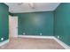 Empty bedroom featuring neutral carpet, green-painted walls, white trim, and standard ceiling fan at 2353 Woodcreek Crossing Blvd, Avon, IN 46123