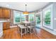 Charming dining area with a brick accent wall and views of the outdoor living space at 2353 Woodcreek Crossing Blvd, Avon, IN 46123
