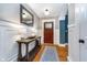 Welcoming foyer with hardwood floors, wainscoting, and a decorative mirror over a console table at 2353 Woodcreek Crossing Blvd, Avon, IN 46123