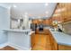 Spacious kitchen features wood floors, cabinets, stainless steel appliances, and a center island with bar seating at 2353 Woodcreek Crossing Blvd, Avon, IN 46123