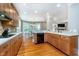 Open kitchen overlooking a dining area and living room with fireplace at 2353 Woodcreek Crossing Blvd, Avon, IN 46123