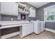 Well-organized laundry room with built-in storage, countertop space, sink, and washer and dryer at 2353 Woodcreek Crossing Blvd, Avon, IN 46123