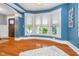 Bright living room featuring bay window, hardwood floors and craftsman trim at 2353 Woodcreek Crossing Blvd, Avon, IN 46123