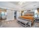 Spacious main bedroom with tray ceiling, neutral color scheme, and a glimpse into an ensuite bathroom at 2353 Woodcreek Crossing Blvd, Avon, IN 46123