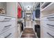 Organized walk-in closet featuring custom shelving, drawers, hanging rods, and wood flooring at 2353 Woodcreek Crossing Blvd, Avon, IN 46123