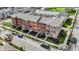 Aerial shot of multi-colored brick townhomes with well-maintained landscaping and car parking at 2627 Congress St, Carmel, IN 46032
