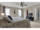 Neutral toned bedroom with windows allowing for natural light and access to the bathroom at 2627 Congress St, Carmel, IN 46032