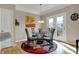 Bright breakfast nook features a modern chandelier, abstract art, and access to a balcony at 2627 Congress St, Carmel, IN 46032