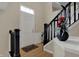 Inviting entryway featuring beautiful hardwood floors, black staircase railing, and classic decor at 2627 Congress St, Carmel, IN 46032