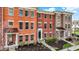 Exterior shot of colorful townhomes with brick facade and front yard landscaping at 2627 Congress St, Carmel, IN 46032