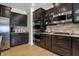Modern kitchen featuring stainless steel appliances, dark cabinets, and stylish backsplash at 2627 Congress St, Carmel, IN 46032