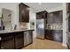 Modern kitchen featuring stainless steel appliances, dark cabinetry, tile backsplash, and functional layout at 2627 Congress St, Carmel, IN 46032