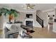 Comfortable living room featuring a fireplace, decorative ceiling fan, and stylish decor elements at 2627 Congress St, Carmel, IN 46032