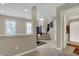 Bright and spacious living area with staircase, tile flooring, and views into the bathroom at 2627 Congress St, Carmel, IN 46032
