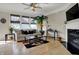 Bright living room with a fireplace, ceiling fan, large windows, and contemporary decor at 2627 Congress St, Carmel, IN 46032