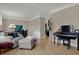Inviting living room featuring a cozy chair, piano, wood floors and elegant decor for comfortable living at 2627 Congress St, Carmel, IN 46032