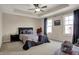 Serene main bedroom with tray ceiling, ceiling fan, and large windows for natural light at 2627 Congress St, Carmel, IN 46032