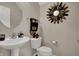 Elegant powder room features a pedestal sink, decorative mirror, and tasteful accents at 2627 Congress St, Carmel, IN 46032
