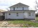 View of the back of the house showing a yard and rear entry door at 2811 S Elm St, Muncie, IN 47302