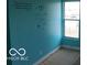 A bedroom featuring turquoise walls and a window overlooking the outside at 2811 S Elm St, Muncie, IN 47302