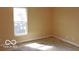 Bedroom featuring natural light from a window, neutral walls, and wood floors at 2811 S Elm St, Muncie, IN 47302