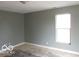 Bedroom featuring natural light from a window, gray walls, and wood floors at 2811 S Elm St, Muncie, IN 47302