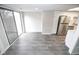 Living room with sliding glass doors to the patio, gray flooring and view to kitchen at 2862 Punto Alto Ct, Indianapolis, IN 46227