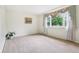 Bright, carpeted bedroom with large windows adorned with floral valances at 2910 S Sheridan Ave, Indianapolis, IN 46203