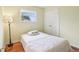 Small bedroom features a twin bed, wooden floors, a window with natural light, and a closet at 2910 S Sheridan Ave, Indianapolis, IN 46203