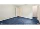 Spacious bedroom featuring blue carpet and light blue walls, with a closet and two doorways at 2910 S Sheridan Ave, Indianapolis, IN 46203