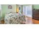 Bedroom features two windows, hardwood floors, and en-suite bathroom at 2910 S Sheridan Ave, Indianapolis, IN 46203