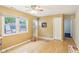 Dining area features wood floors, a ceiling fan, a window, and neutral paint at 2910 S Sheridan Ave, Indianapolis, IN 46203