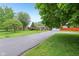 Charming ranch home features a large driveway and an attached two-car garage, complemented by a lush lawn at 2910 S Sheridan Ave, Indianapolis, IN 46203