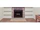 Living room featuring a brick fireplace with built in shelves, and tile hearth at 2910 S Sheridan Ave, Indianapolis, IN 46203
