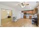 Eat-in kitchen featuring a ceiling fan, a refrigerator, and wood cabinets at 2910 S Sheridan Ave, Indianapolis, IN 46203