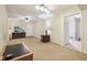Open-concept living room features a ceiling fan, a television, and neutral carpeted flooring at 2910 S Sheridan Ave, Indianapolis, IN 46203