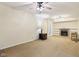 Cozy living room featuring a fireplace, built-in shelving, and a ceiling fan at 2910 S Sheridan Ave, Indianapolis, IN 46203