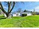 View of back yard, shows two-car garage and back of single story home at 3015 E Sumner Ave, Indianapolis, IN 46237