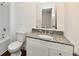 Bathroom featuring a shower-tub combo, granite countertop vanity, and modern fixtures at 3015 E Sumner Ave, Indianapolis, IN 46237