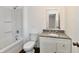 Bathroom featuring a shower-tub combo, granite countertop vanity, and modern fixtures at 3015 E Sumner Ave, Indianapolis, IN 46237