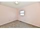 Bedroom featuring neutral carpet, pale pink walls, and a window offering natural light at 3015 E Sumner Ave, Indianapolis, IN 46237