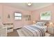 Bright bedroom with a neutral color palette, framed art, and plush bedding at 3015 E Sumner Ave, Indianapolis, IN 46237
