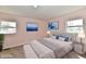 Primary bedroom featuring neutral furniture, beach-themed artwork, and plush bedding at 3015 E Sumner Ave, Indianapolis, IN 46237