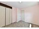 Bedroom featuring neutral carpet, light pink paint and two closets for ample storage space at 3015 E Sumner Ave, Indianapolis, IN 46237