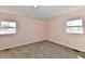 Bedroom with two windows letting in lots of natural light and neutral carpeting at 3015 E Sumner Ave, Indianapolis, IN 46237