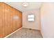 This bedroom features wood paneling, neutral walls, carpeted floors, and a window at 3015 E Sumner Ave, Indianapolis, IN 46237
