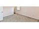 Neutral carpeted bedroom with natural light and a closet space visible through the doorway at 3015 E Sumner Ave, Indianapolis, IN 46237